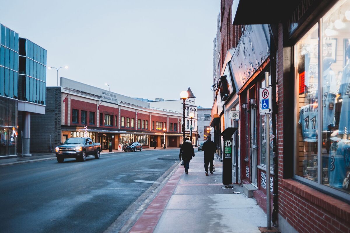 Pedestrians walking past boutique storefronts near Decatur Square in Decatur, GA